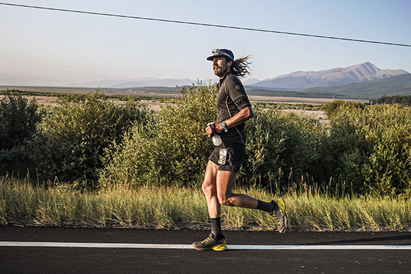 Anton Krupicka running on the road at Leadville 100