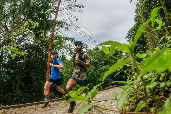 Kyle and Odin running through the jungle