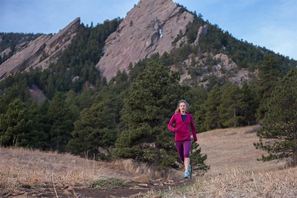Clare Gallagher running by the Flatirons