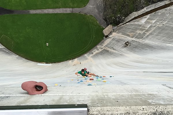 Climber on the Diga di Luzzone artificial climbing wall