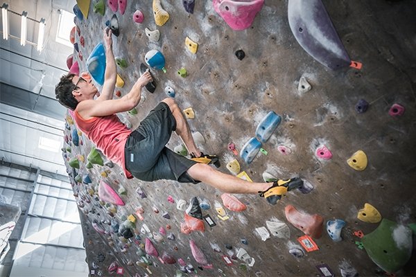 Climber bouldering in the gym