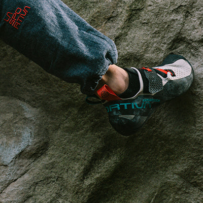 A closeup of a female climber's foot on a rock wall