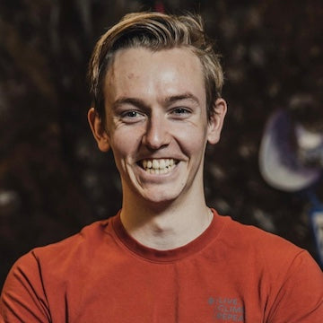 Person wearing a red shirt with a blurred background