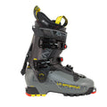 The La Sportiva Vanguard is a gray and black ski boot with yellow accents, multiple buckles, a power strap, and a rugged sole—perfect for ski touring or adventure skiing in the backcountry.