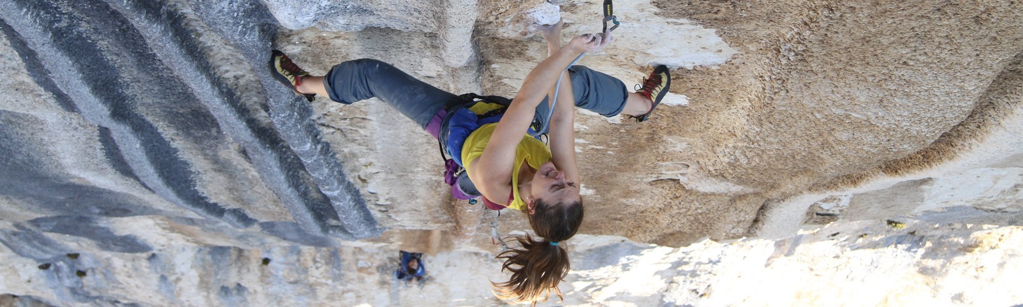 Person rock climbing on a steep cliff face