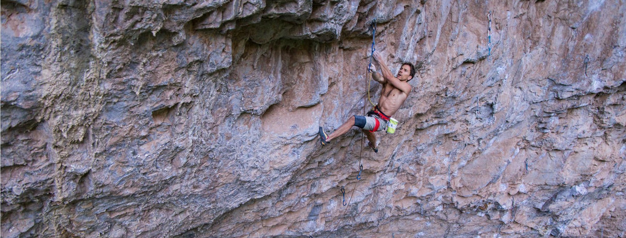 Man climbing a rocky cliff face
