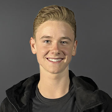Person wearing a black jacket on a gray background