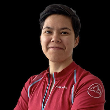 Person wearing a red sports jacket with visible branding on a black background