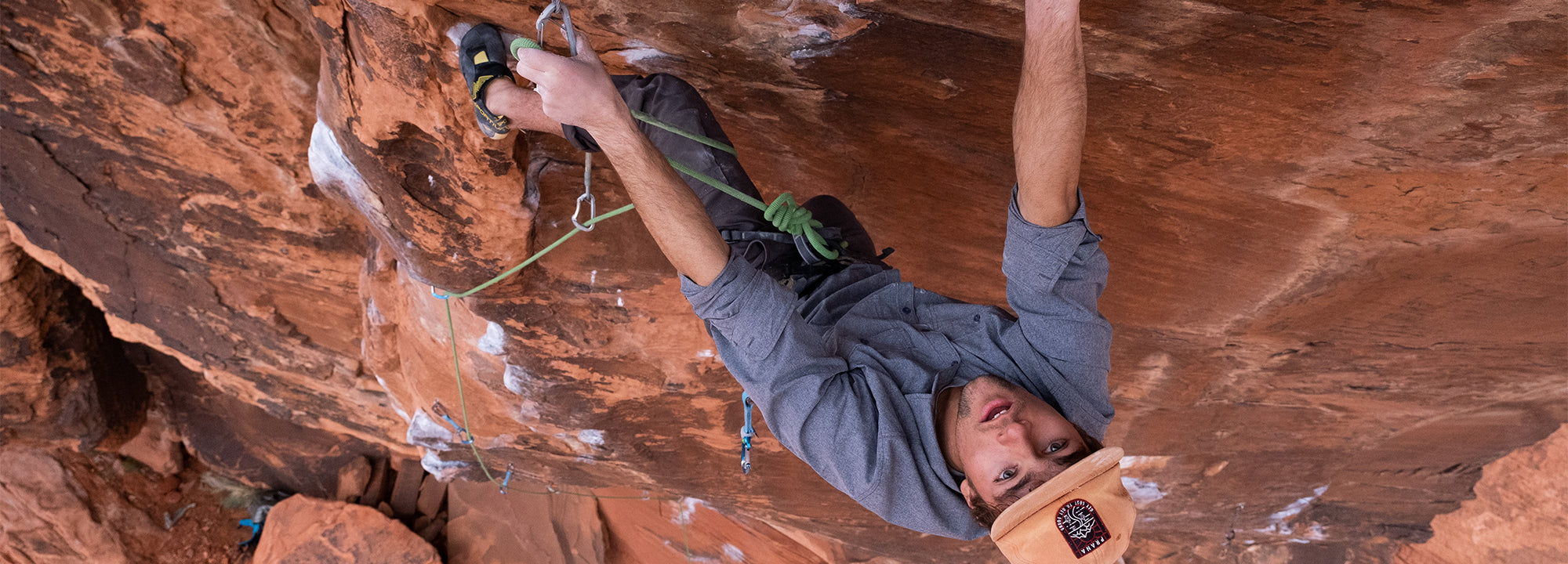 Person rock climbing on a red rock wall