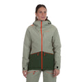 A woman with brown hair pulled back stands against a white background, wearing the La Sportiva Chaser EVO Shell Jacket Women's in light gray and dark green with orange zippers, reflective details, and underarm ventilation. She looks slightly to the side.