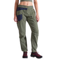 Une personne portant un pantalon La Sportiva Labyrinth Pants Women's en vert olive avec une ceinture ajustable et des poches marines, un haut court vert et des chaussures de randonnée noires et rouges, se tient debout sur un fond blanc.
