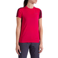 A woman wears the La Sportiva Just Right T-Shirt Women's in bright pink with dark red sleeves and dark pants, standing with her arms relaxed by her sides against a plain white background.