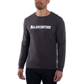 A man stands against a white background wearing the La Sportiva Heritage Logo Sweater Men’s in dark gray, featuring “La Sportiva” printed in white across the chest and highlighting its classic design and outdoor appeal.
