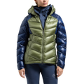 A person wearing the La Sportiva Lumina 300 Down Jacket Women’s—a shiny, two-tone puffer jacket with olive green on the front and blue on the sleeves and sides—paired with blue pants. This lightweight La Sportiva jacket features a hood and a front zipper for added warmth and style.