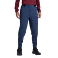 A person models the La Sportiva Nordend Primaloft Pants Men's in blue, paired with a maroon long-sleeve top and black hiking boots. Only the lower half of their body is visible against a white background.
