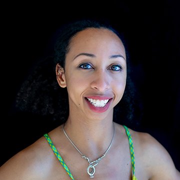 Woman with a bright smile against a black background