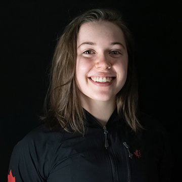 Person wearing a black jacket with a red logo on a black background